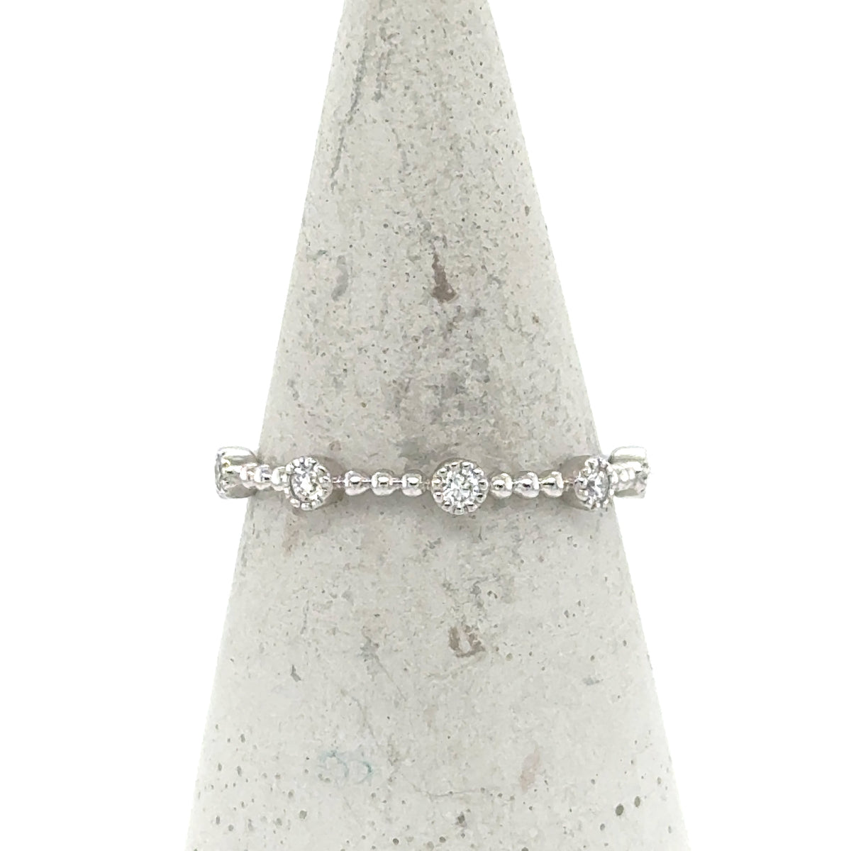 14K white gold stackable band with round pavé diamond stations and beaded shank.
