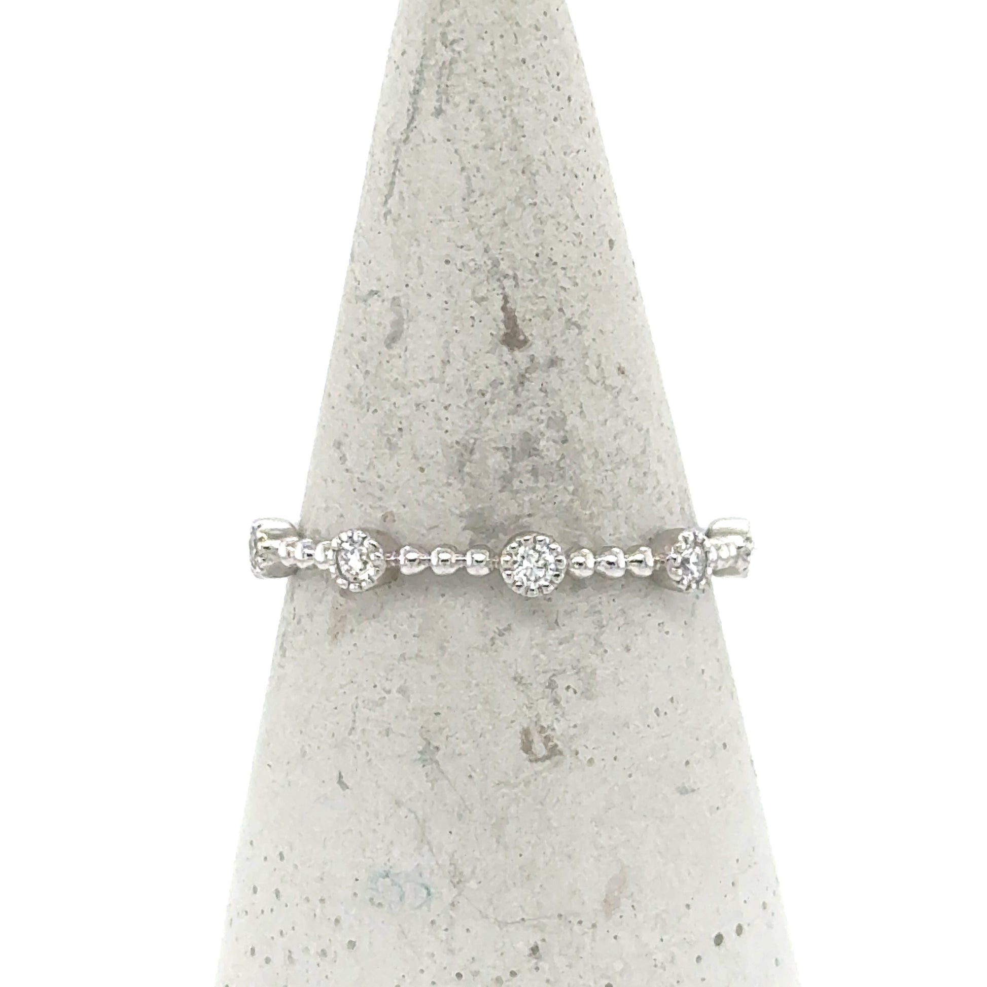 14K white gold stackable band with round pavé diamond stations and beaded shank.