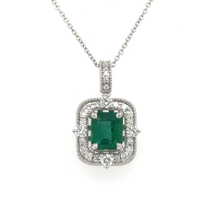 14K white gold pendant with emerald-cut green emerald and diamond halo on chain.