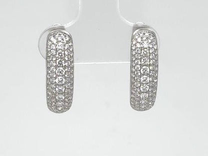 Oval 18K white gold hoop earrings paved with round brilliant diamonds.
