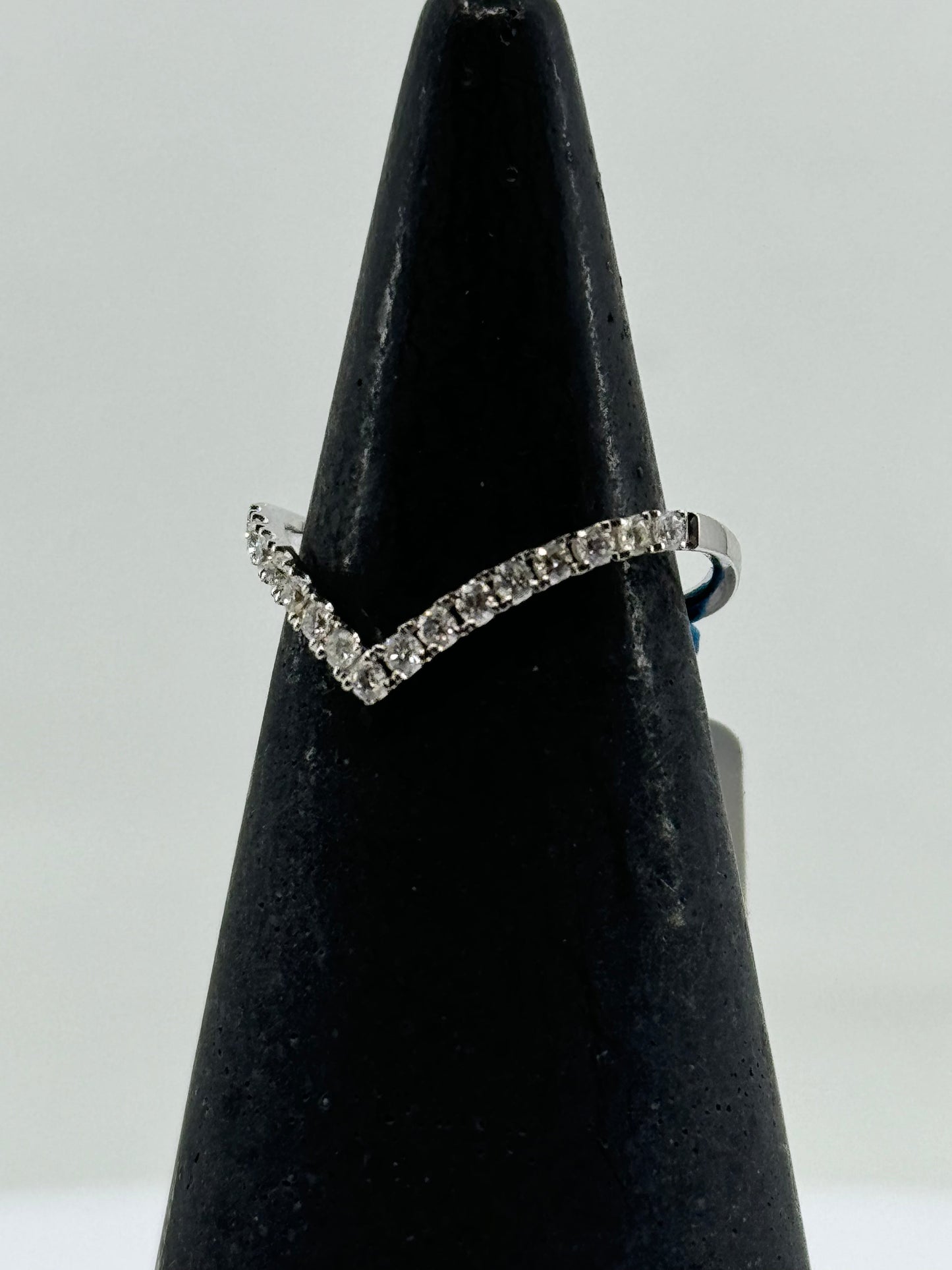 14K white gold chevron ring with round diamond pavé on a slim band.