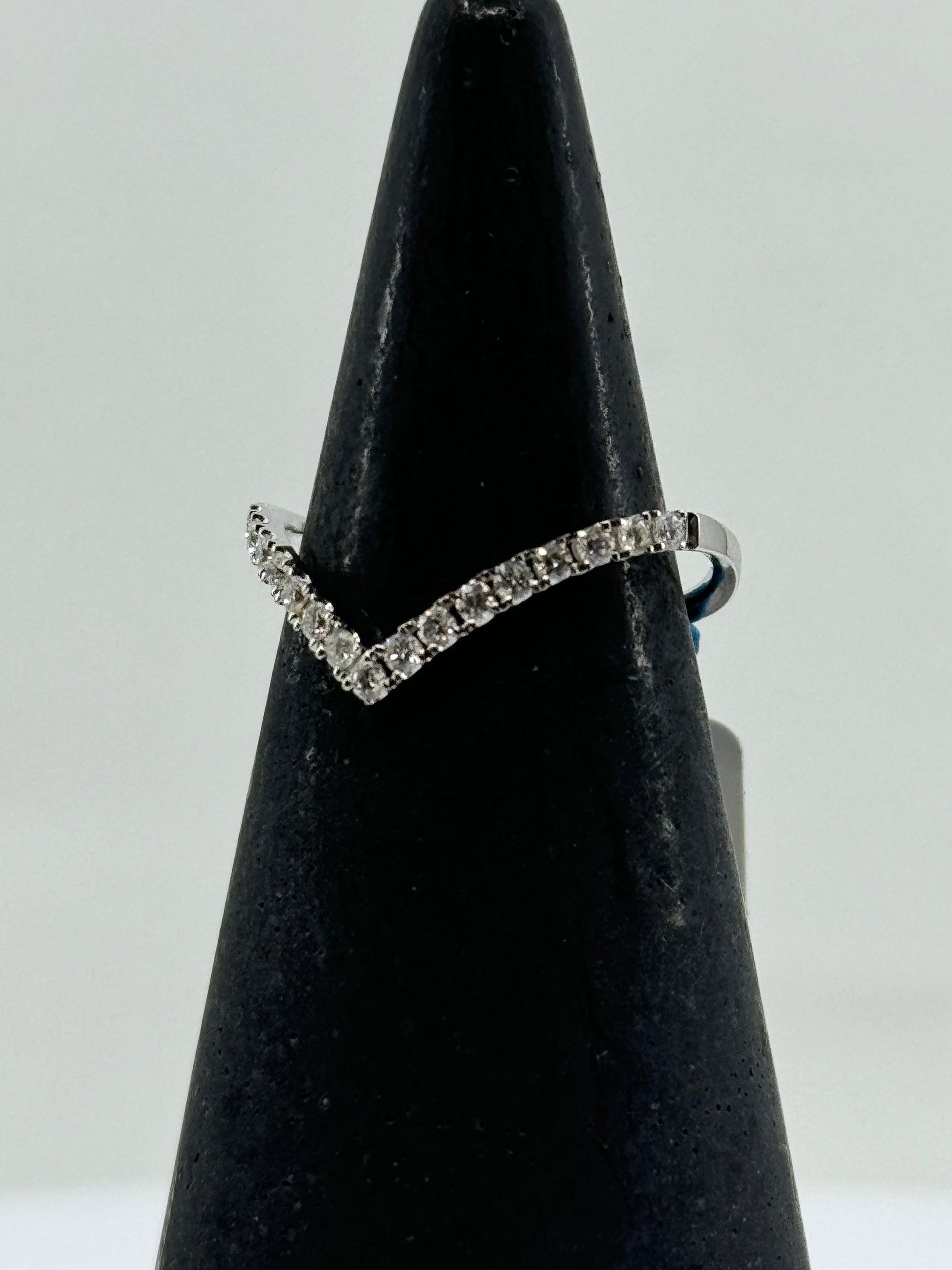 14K white gold chevron ring with round diamond pavé on a slim band.