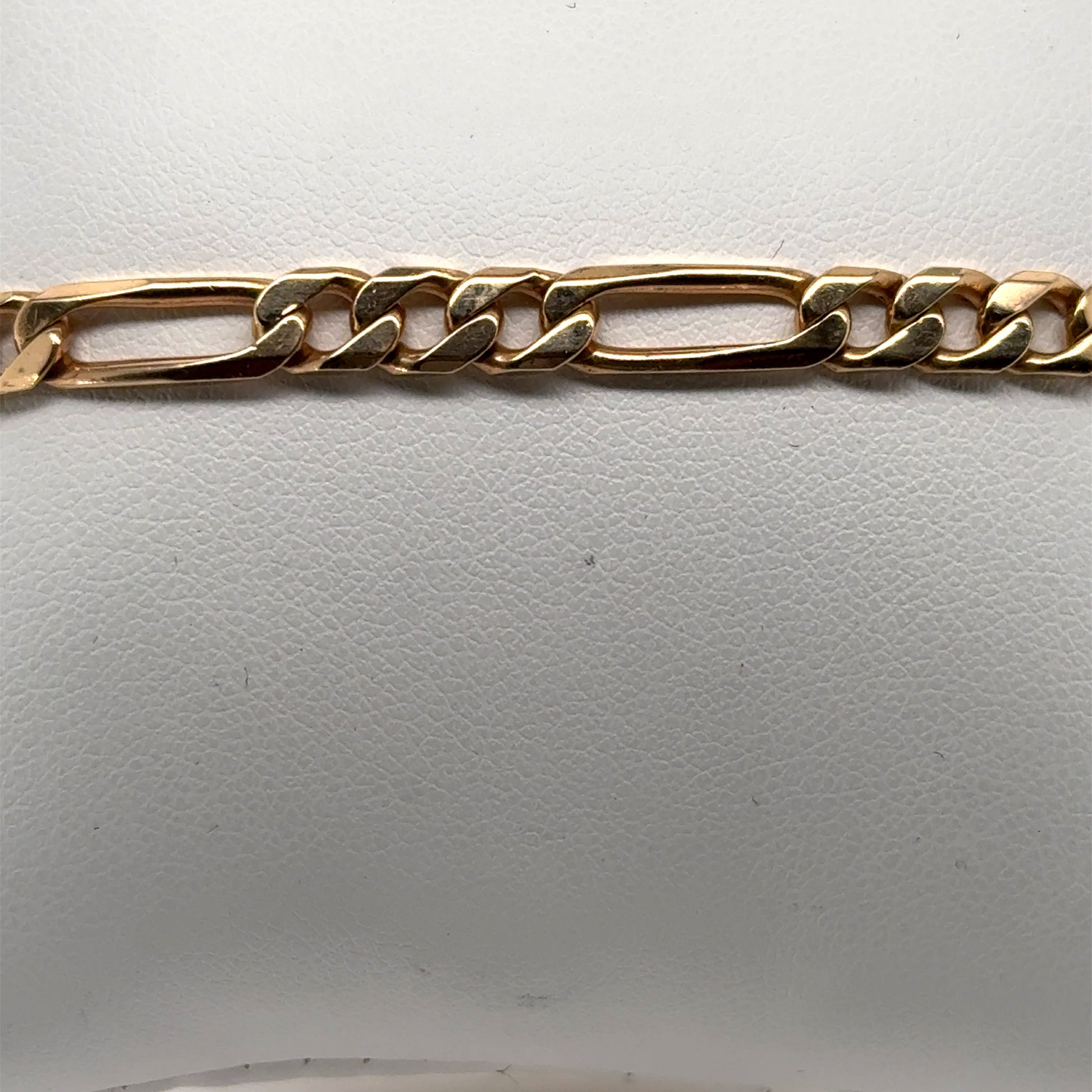 14K yellow gold Figaro bracelet with alternating elongated and curb links.