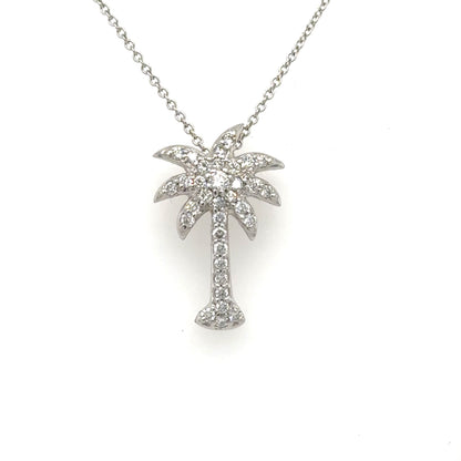 White gold diamond pavé palm tree pendant on a fine chain.
