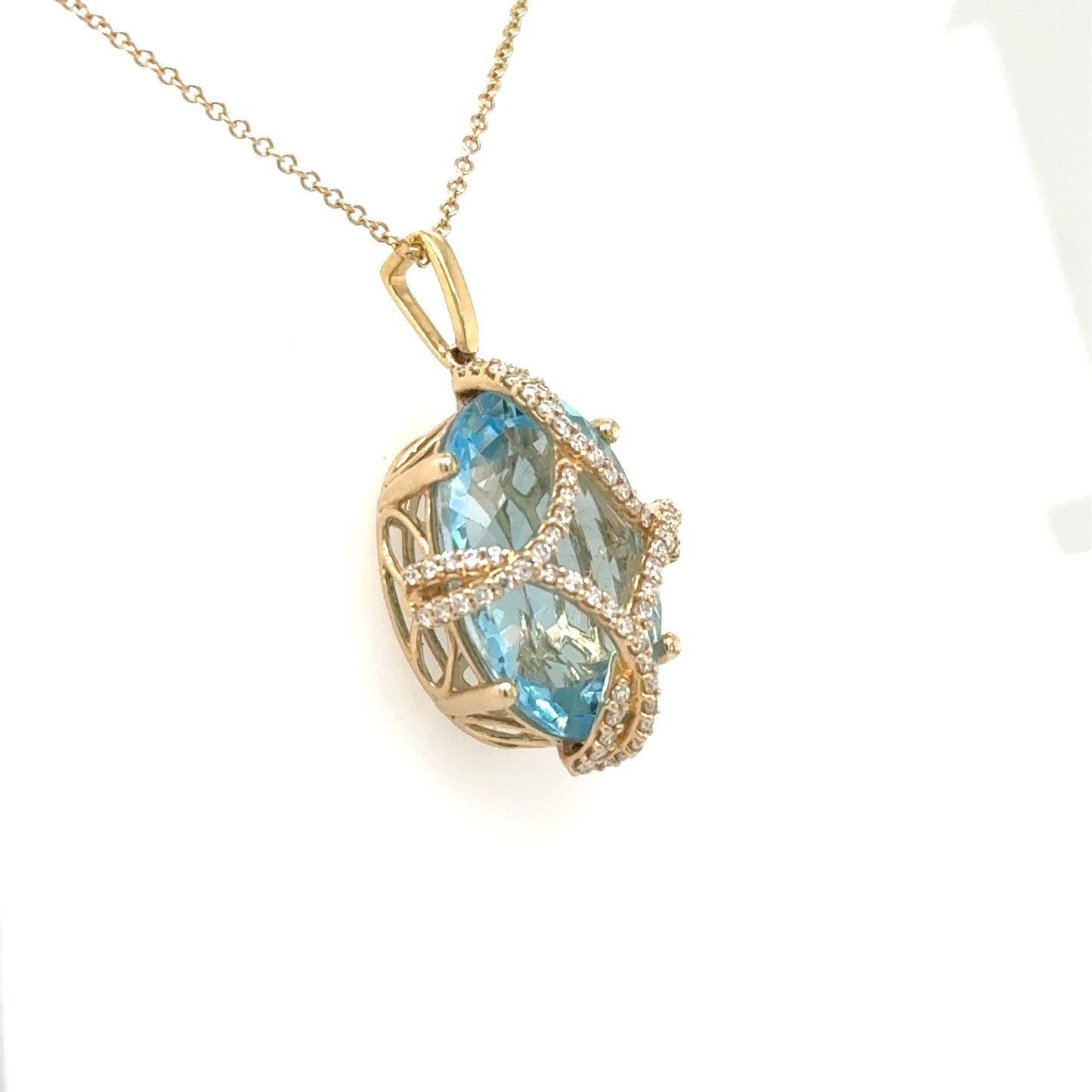 14K yellow gold pendant with oval Swiss blue topaz and diamond lattice setting.