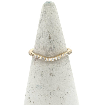 Curved 14K yellow gold band with a pavé row of round diamonds.