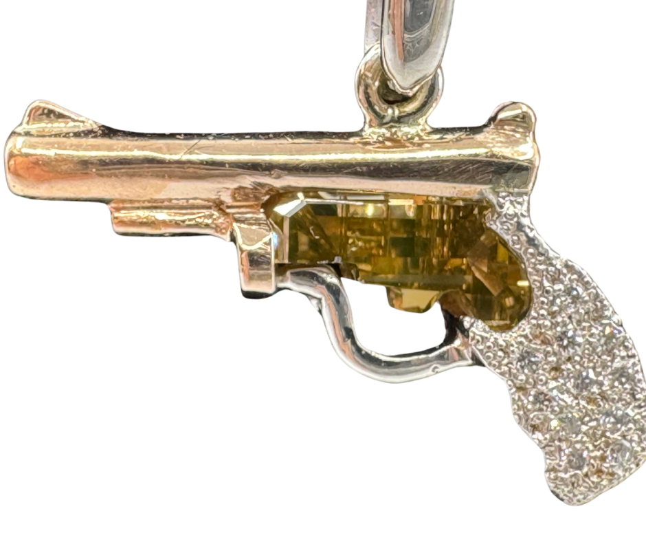 14K rose and white gold pistol pendant with yellow diamond center and pavé diamond grip.