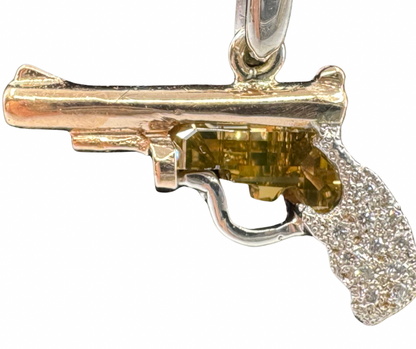 14K rose and white gold pistol pendant with yellow diamond center and pavé diamond grip.