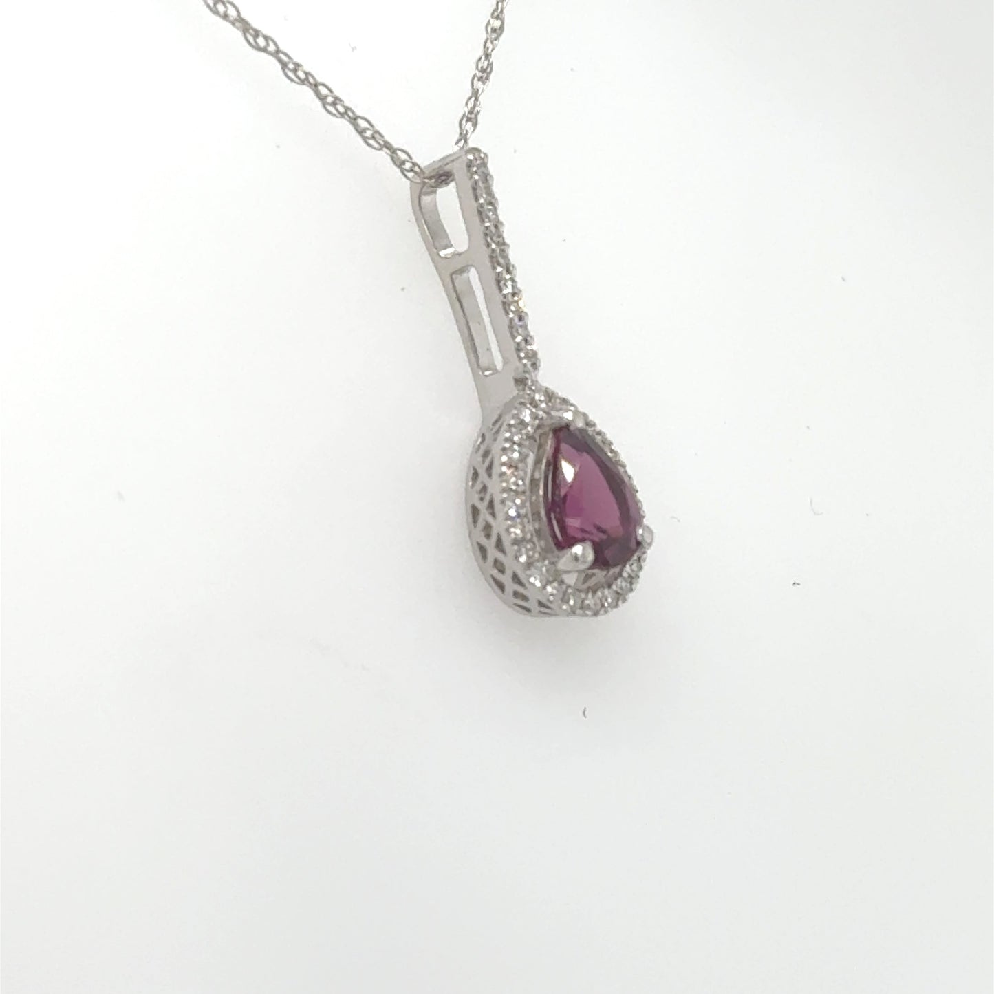 14K white gold pendant with pear-shaped rhodolite garnet and diamond halo.