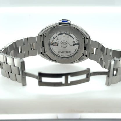 Stainless steel Cartier watch showing exhibition caseback, automatic movement, bracelet, and deployant clasp.