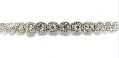 14K white gold tennis bracelet with round diamonds in halo link settings.