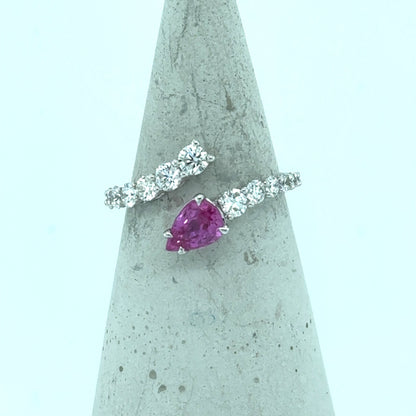 18K white gold bypass ring with pear-cut pink sapphire and diamond band.