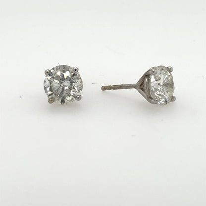 Round brilliant diamond stud earrings in 14K white gold, four-prong martini settings.