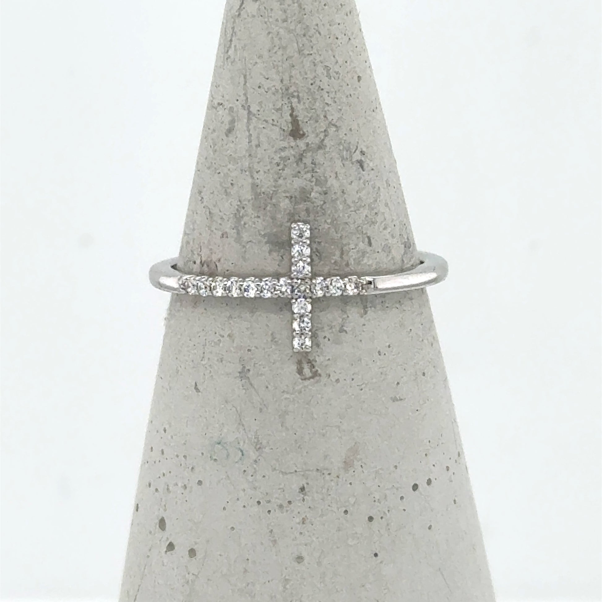 14K white gold ring with a sideways diamond cross on a thin band.