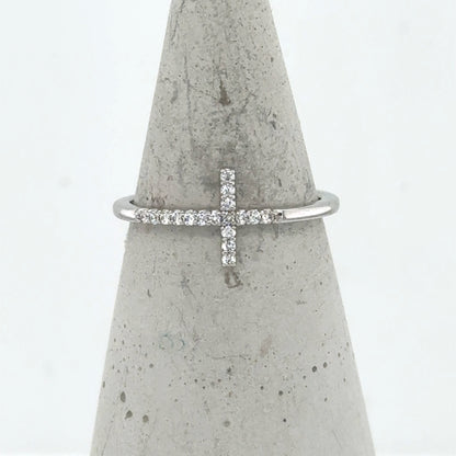 14K white gold ring with a sideways diamond cross on a thin band.