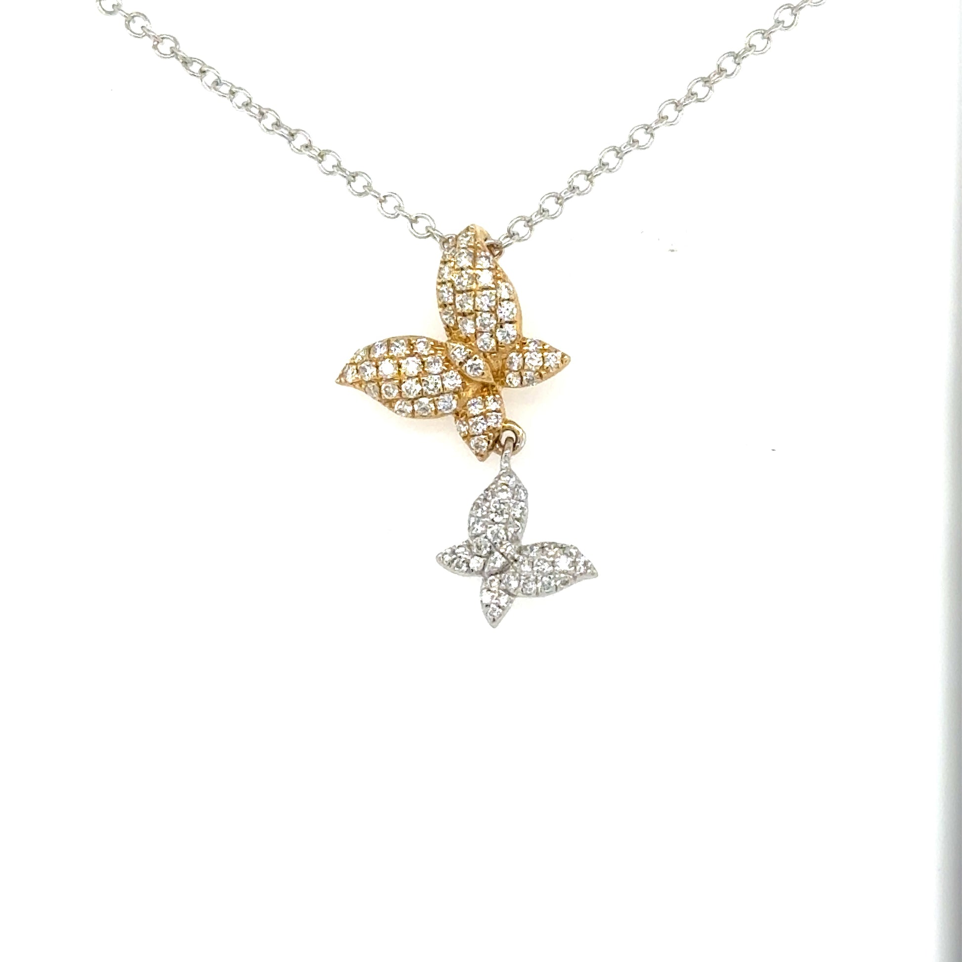 Two diamond-pavé butterfly pendants in yellow and white gold on a white gold chain.
