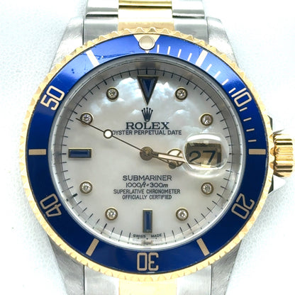Two-tone steel and yellow gold Submariner with blue bezel, mother-of-pearl dial, diamond markers, and date magnifier.