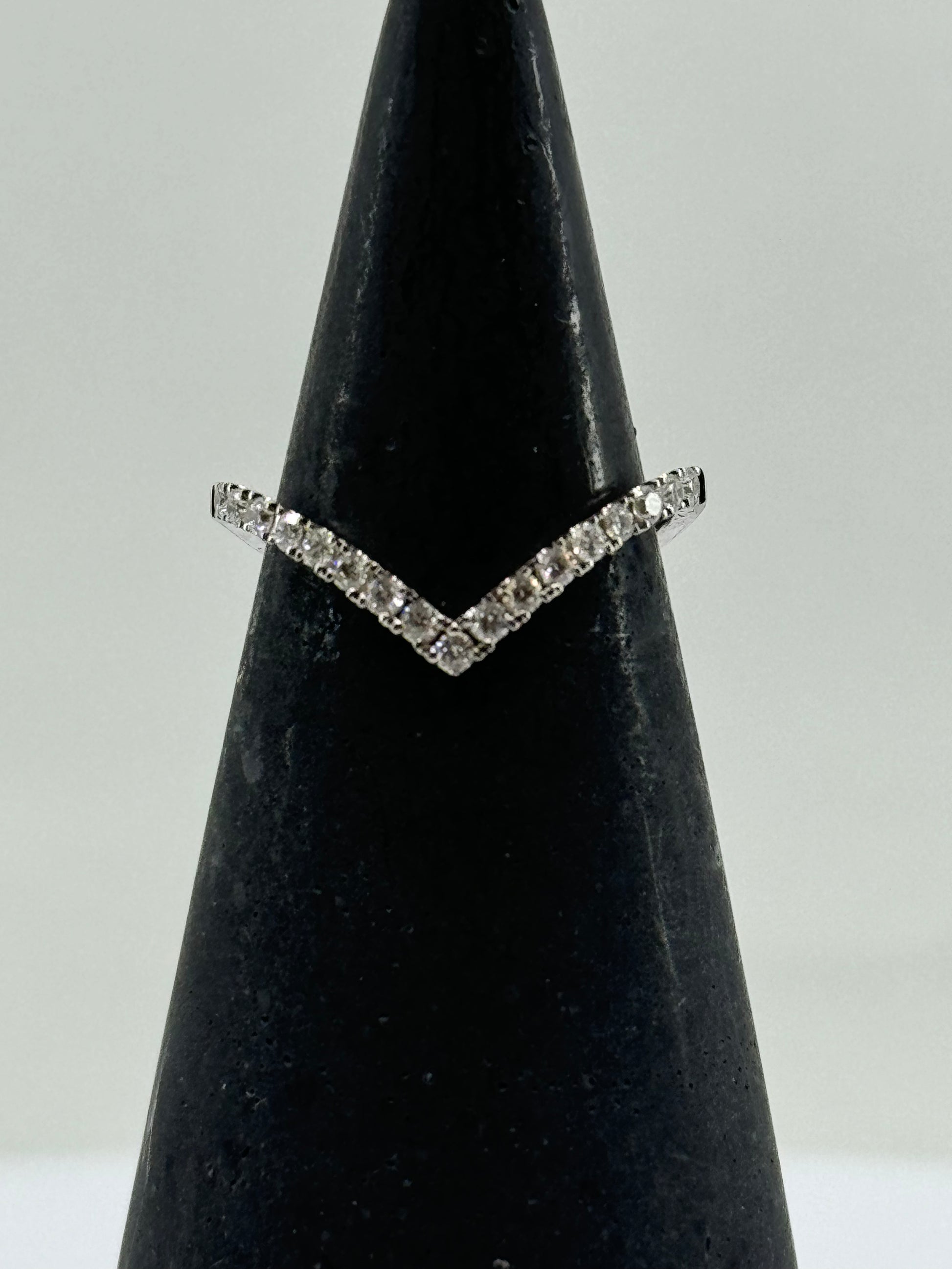14K white gold chevron ring with pavé-set round diamonds on a V-shaped band.