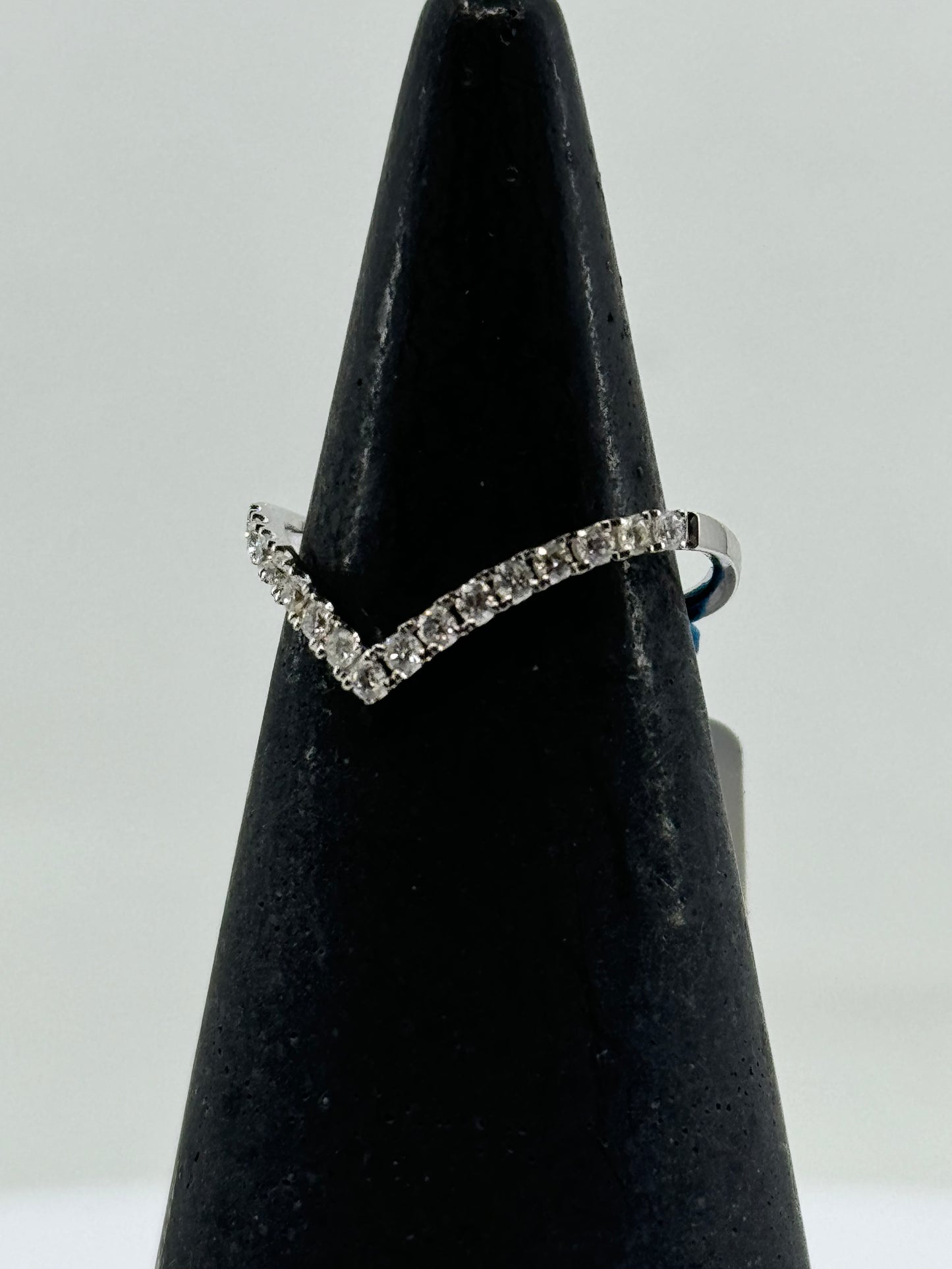 14K white gold chevron ring with round diamond pavé on a slim band.