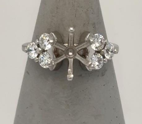Platinum semi-mount ring with six round diamonds flanking an empty center setting.