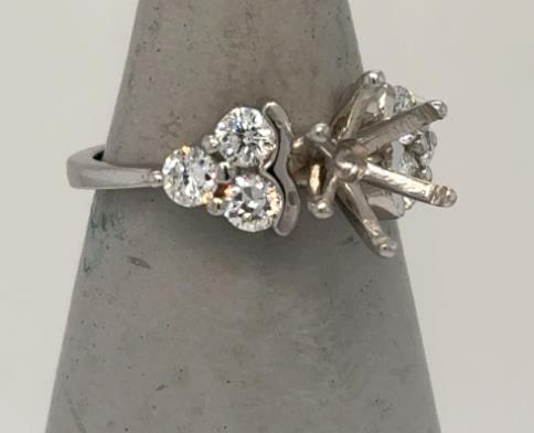 Platinum semi-mount ring with six round diamonds and empty six-prong center setting.
