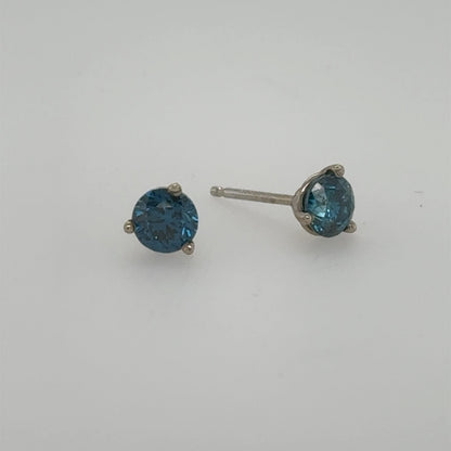 Blue round-cut diamond stud earrings in 14K white gold three-prong settings.