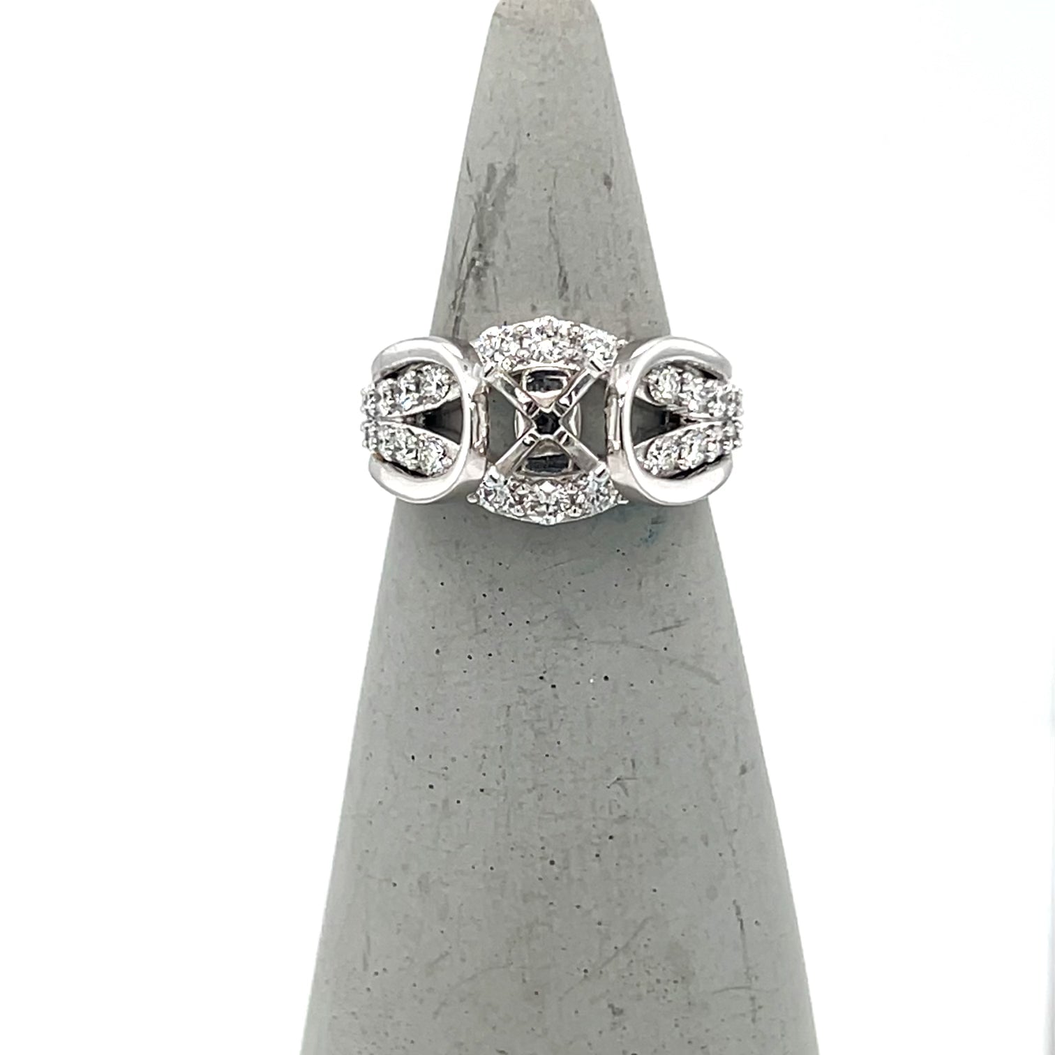 Semi-mount engagement ring with pavé diamond arches and empty center setting.