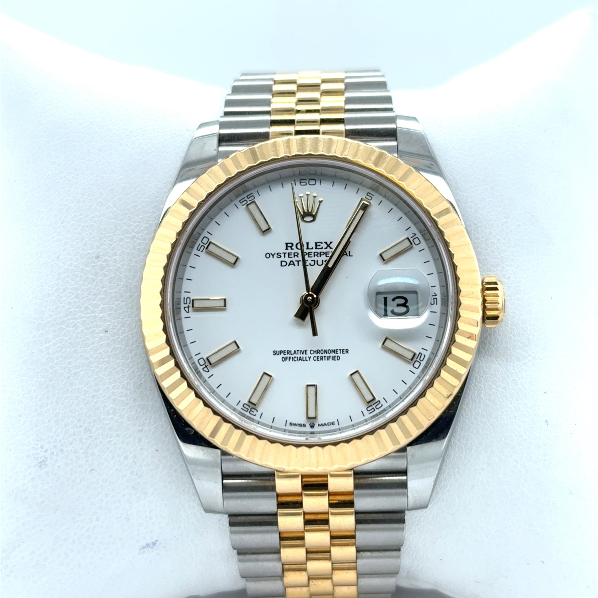 Two-tone Rolex Datejust with white dial, fluted yellow-gold bezel, Jubilee bracelet, date window.