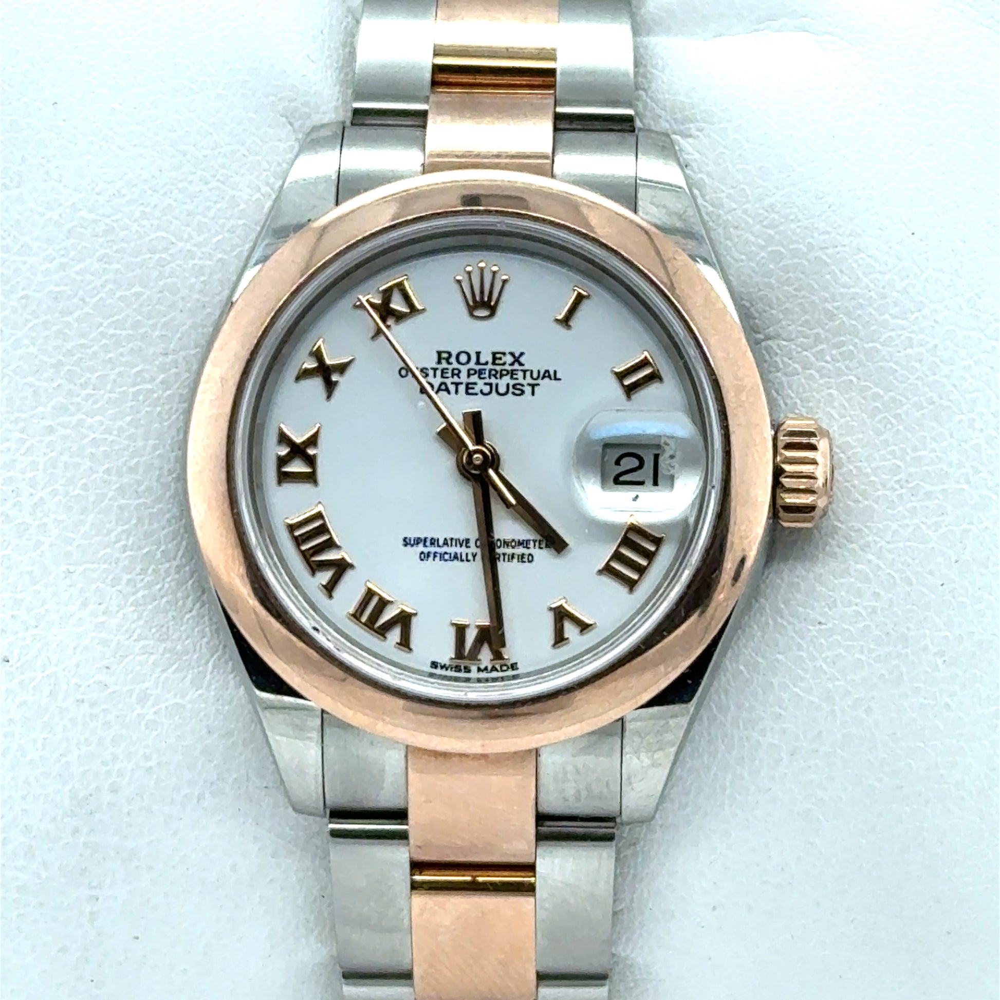 Two-tone stainless steel and rose gold Datejust with white dial, Roman numerals, date window.