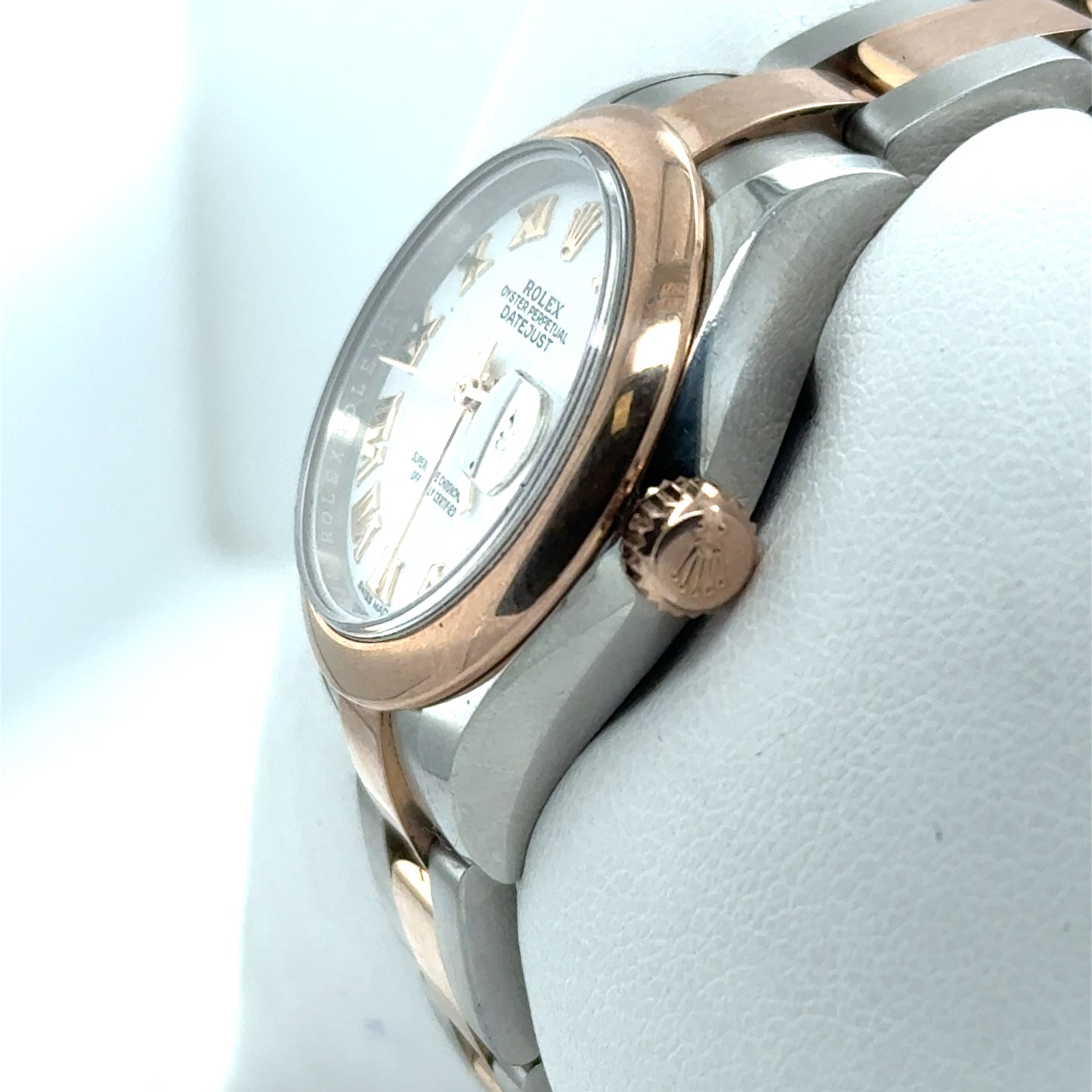 Two-tone stainless steel and rose gold Datejust with white dial and Roman numerals.