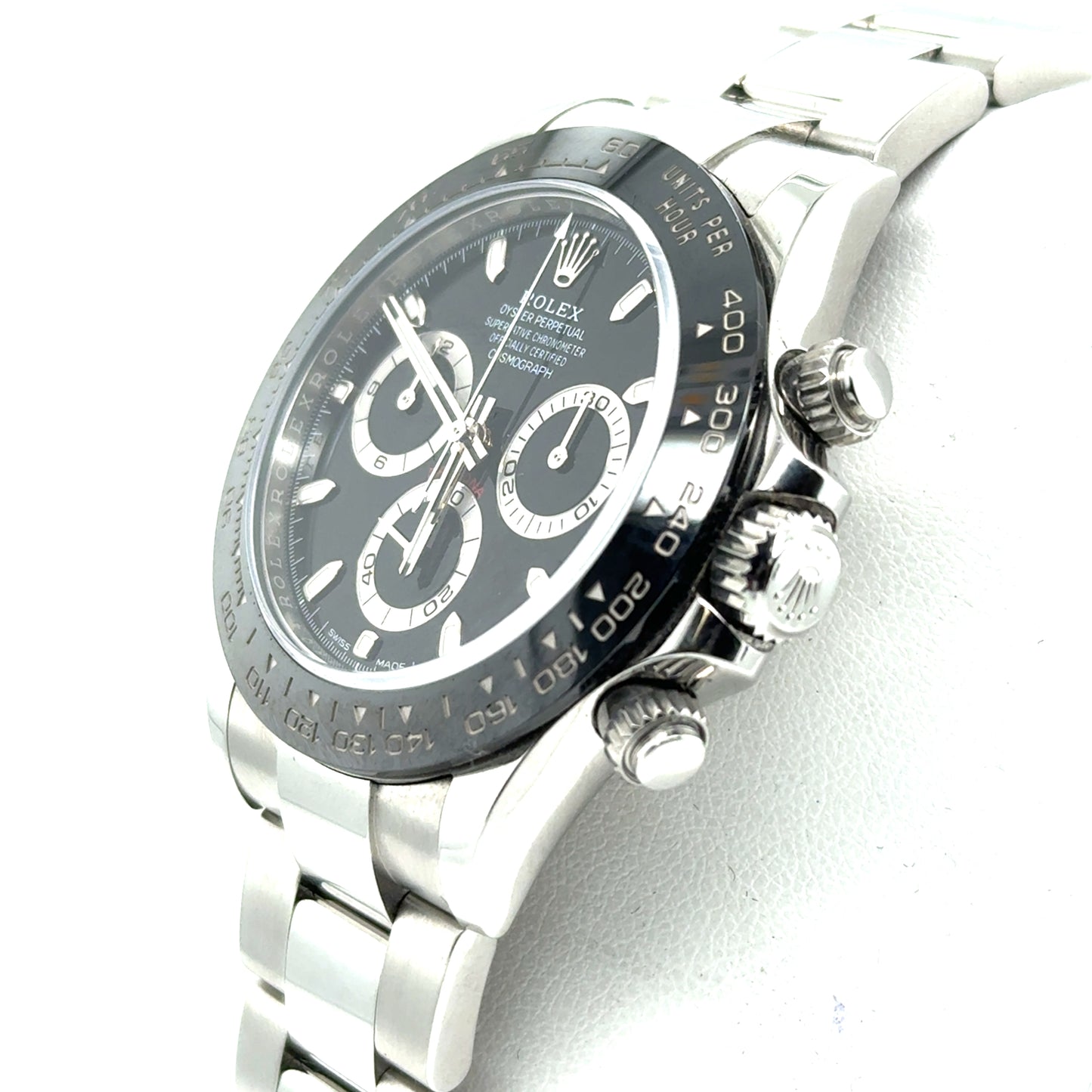 Stainless steel chronograph watch with black dial, ceramic tachymeter bezel, and Oyster bracelet.