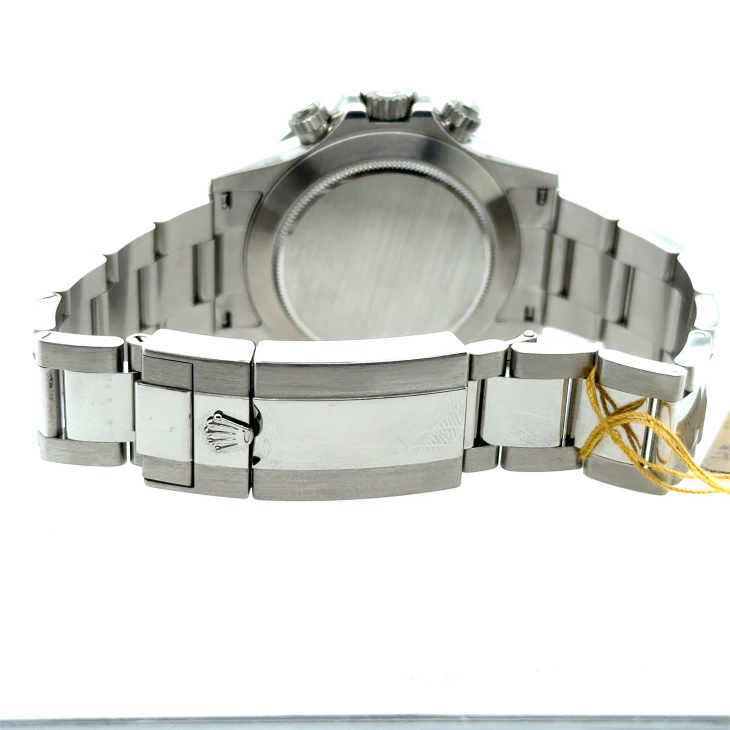 Stainless steel Rolex Oyster bracelet and clasp, caseback view with yellow tag.