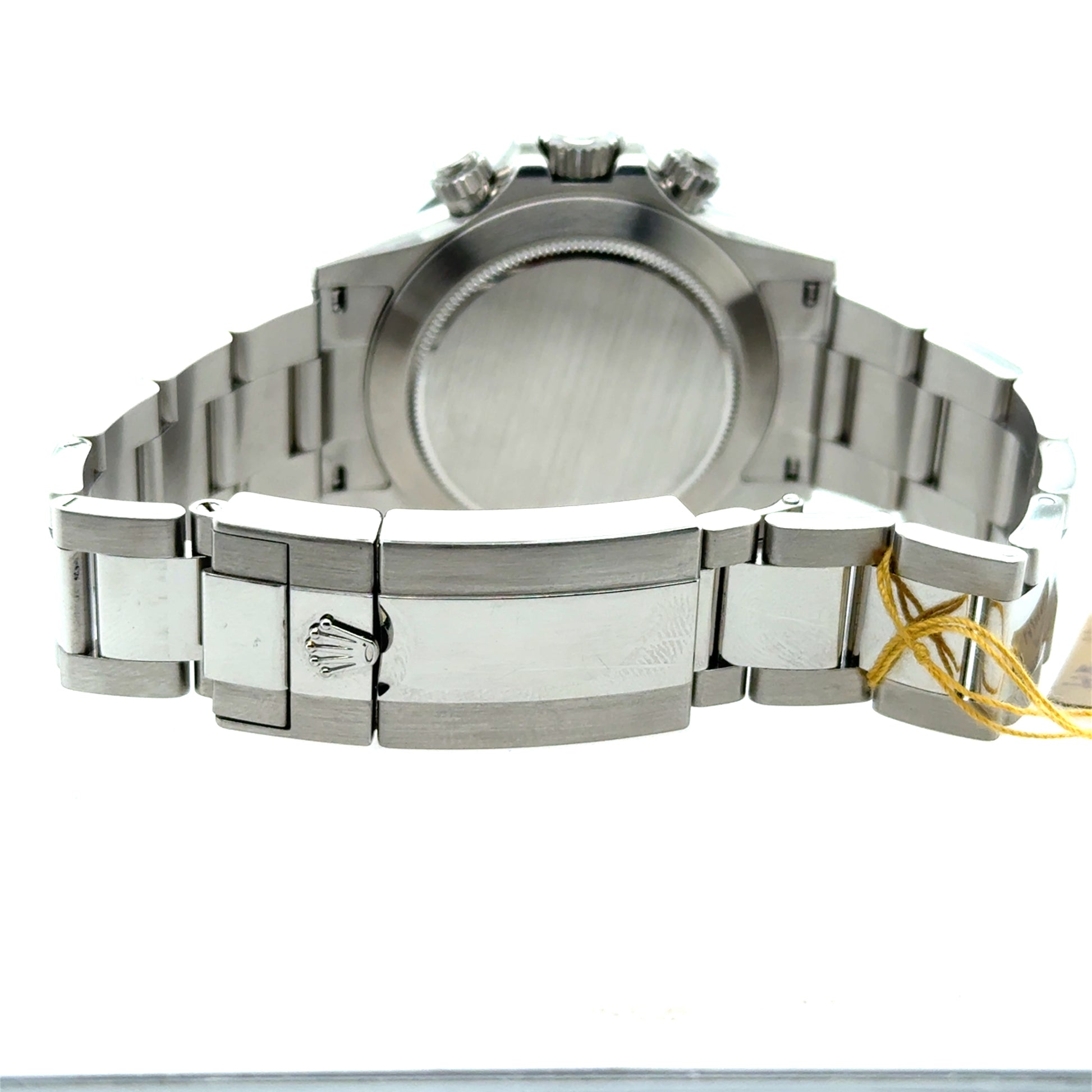 Stainless steel Rolex Oyster bracelet and clasp, caseback view with yellow tag.