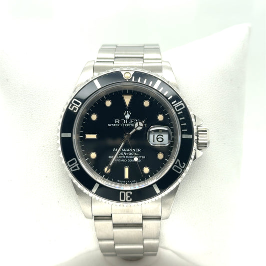 Stainless steel dive watch with black dial, date magnifier, and black rotating bezel.