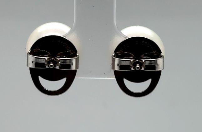 White freshwater pearl stud earrings with sterling silver Happy Backs shown rear view.