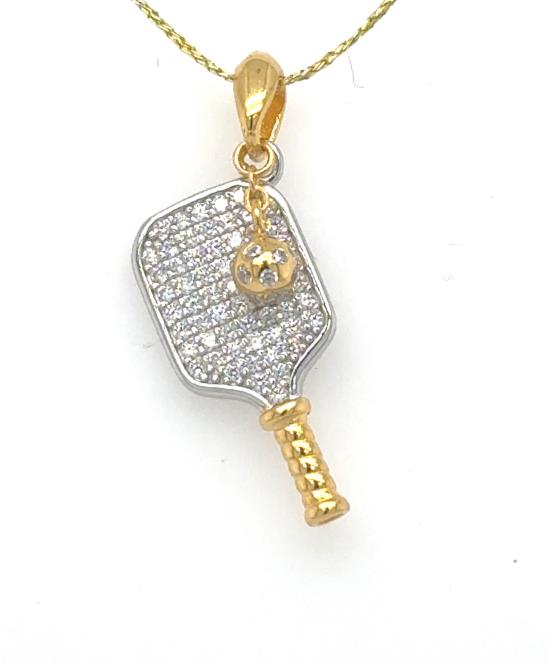 Silver pickleball paddle pendant with pavé cubic zirconia, gold bail, handle, and ball.