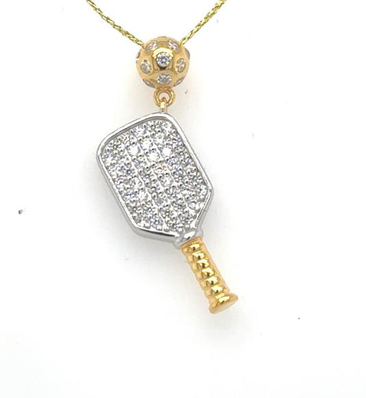Two-tone pickleball paddle pendant with CZ pavé face, gold handle, and perforated gold ball bail.