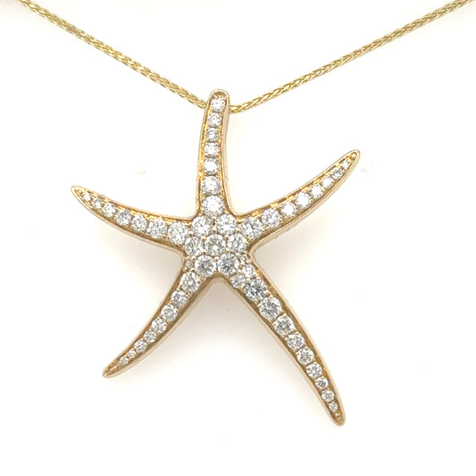 Yellow gold starfish pendant pave-set with round diamonds, shown on a fine chain.