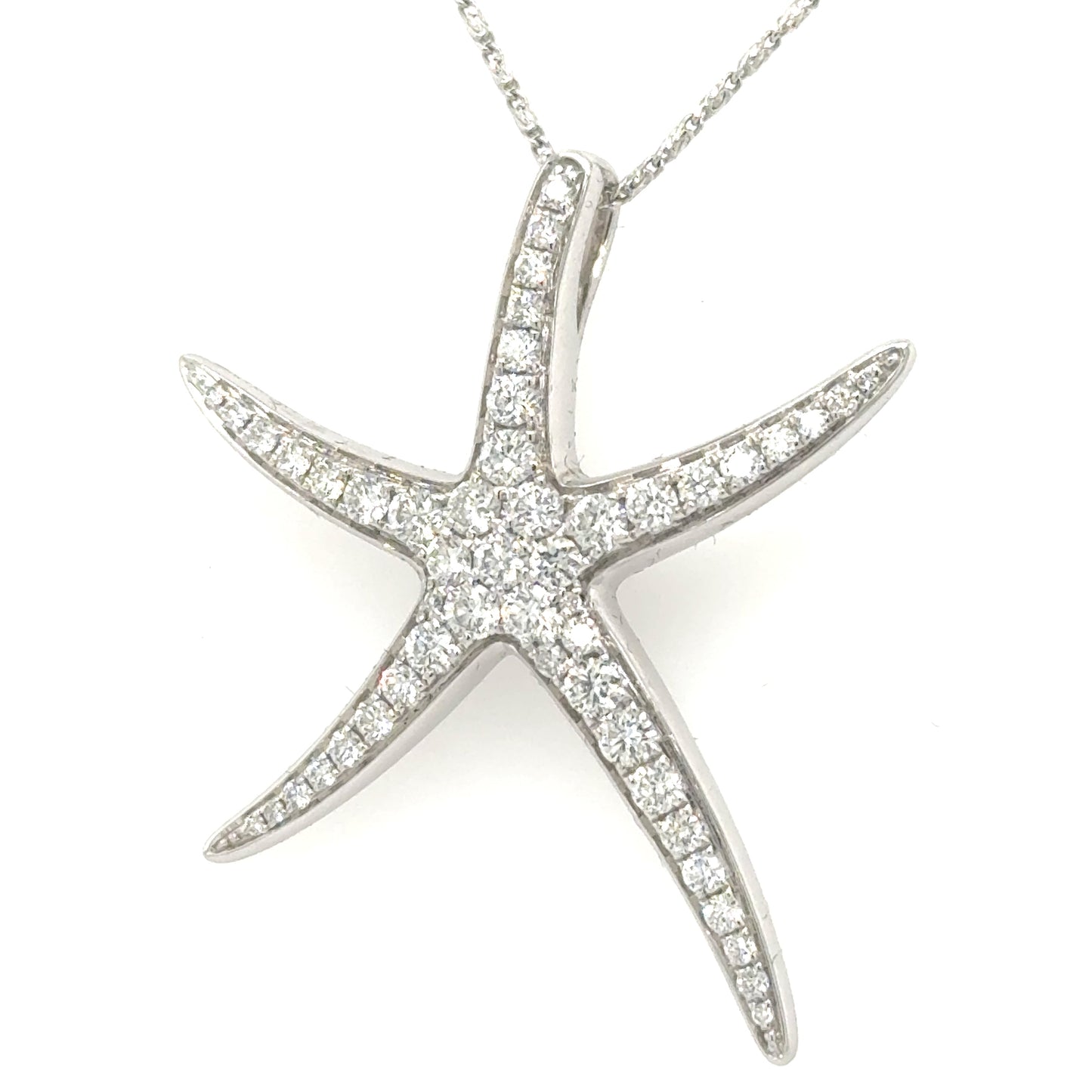 White gold starfish pendant pavé-set with round diamonds, shown on fine chain.