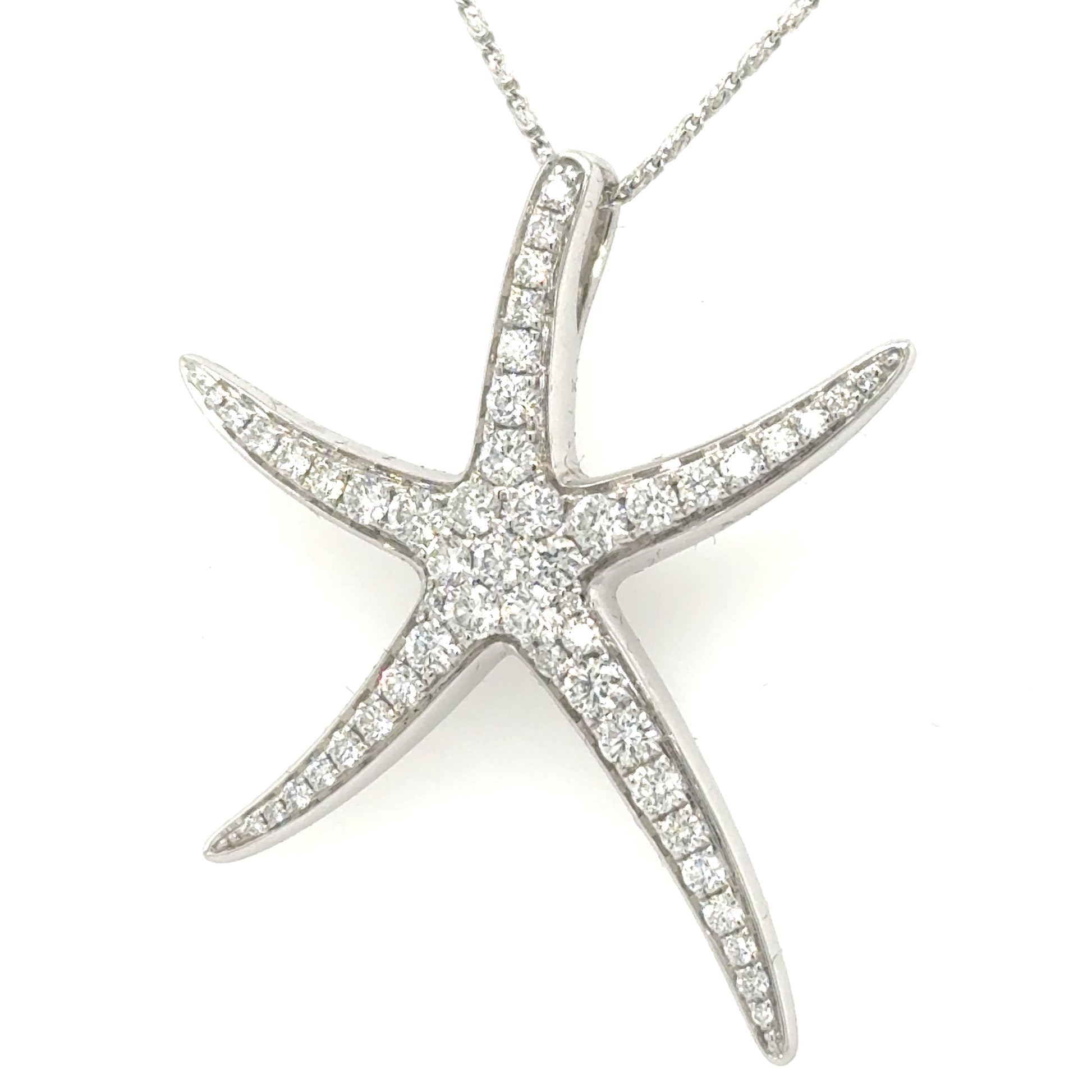 White gold starfish pendant pavé-set with round diamonds, shown on fine chain.