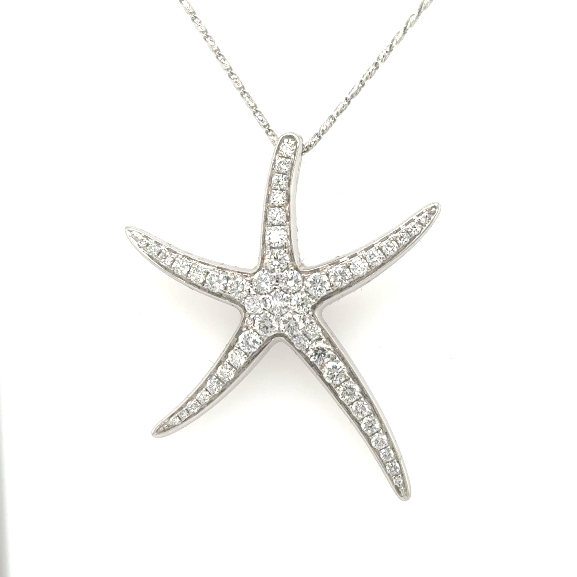 White gold starfish pendant pave-set with round diamonds, shown on a chain.