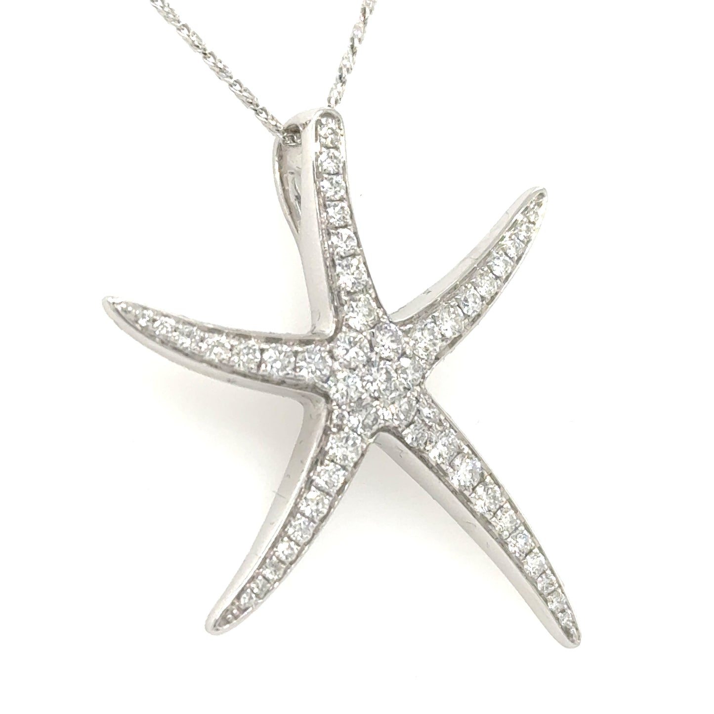 White gold starfish pendant pavé-set with round diamonds, shown on a fine chain.